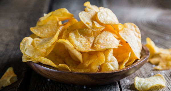 Potato chips on a wooden table